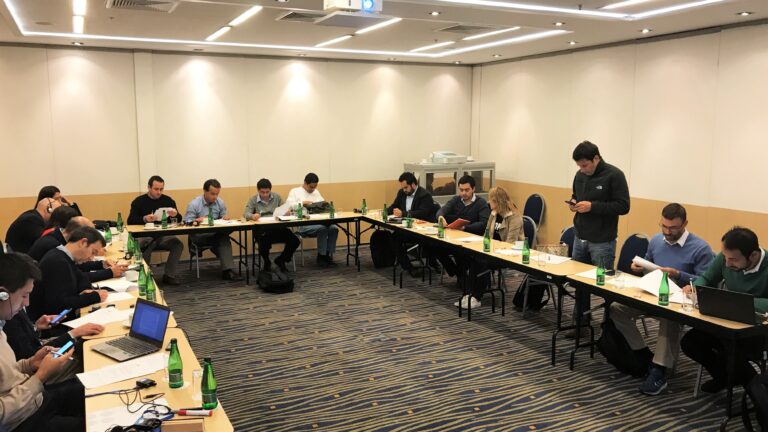 A group of people sitting at tables in a room.